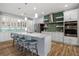 Spacious kitchen featuring white cabinetry, stainless steel appliances, and a subway tile backsplash at 1721 Walden Ct, Englewood, FL 34224