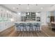 Bright, modern kitchen featuring a large island, stainless steel appliances, and stylish barstool seating at 1721 Walden Ct, Englewood, FL 34224