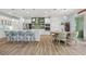 Modern kitchen with an island, stainless steel appliances, and an adjacent dining area with backyard views at 1721 Walden Ct, Englewood, FL 34224