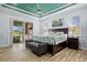 Main bedroom features a tray ceiling, a sliding glass door to the patio, and a view of the pool at 1721 Walden Ct, Englewood, FL 34224