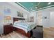 Spacious main bedroom featuring a tray ceiling, natural light, and wood-look floors at 1721 Walden Ct, Englewood, FL 34224