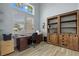 The bright office features custom built-ins, wood-look floors, and plenty of natural light at 1721 Walden Ct, Englewood, FL 34224
