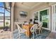 This covered patio includes a dining table, outdoor grill, and bar area for entertaining guests at 1721 Walden Ct, Englewood, FL 34224