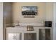 This outdoor kitchen features a sink, stainless steel grill, and sleek marble countertops at 1721 Walden Ct, Englewood, FL 34224