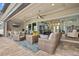 This spacious, covered patio features comfortable seating and a view of the home's interior at 1721 Walden Ct, Englewood, FL 34224