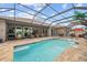 Inviting screened-in pool with outdoor seating, creating an ideal space for relaxation and entertainment at 1721 Walden Ct, Englewood, FL 34224