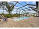 Private screened-in pool with comfortable seating and playful swan floats, perfect for relaxation at 1721 Walden Ct, Englewood, FL 34224