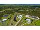 Panoramic aerial shot displays the impressive property with private pond and surrounding wooded landscape at 17400 White Water Ct, Punta Gorda, FL 33982