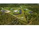 Aerial view of a sprawling estate showcasing the home, ponds, and lush landscaping with boundary lines at 17400 White Water Ct, Punta Gorda, FL 33982