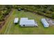 Aerial view of a charming home with a spacious yard and various trailers, all on a sprawling green lot at 17400 White Water Ct, Punta Gorda, FL 33982