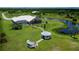 Expansive backyard featuring a gazebo, lush lawn, screened lanai, and a serene pond with a fountain at 17400 White Water Ct, Punta Gorda, FL 33982