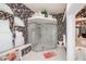 A spacious bathroom featuring a glass-enclosed shower, patterned wallpaper, and a built-in bench at 17400 White Water Ct, Punta Gorda, FL 33982