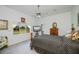 A bedroom with a king size bed, hardwood floors, a ceiling fan, and natural light from the window at 17400 White Water Ct, Punta Gorda, FL 33982