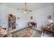 Bright room with ceiling fan, a large window, and is furnished with a tiger and a bookshelf at 17400 White Water Ct, Punta Gorda, FL 33982