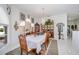 Bright dining area with large windows, elegant chandelier, and seating for six at 17400 White Water Ct, Punta Gorda, FL 33982