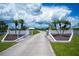 Impressive gated entrance with stately pillars, manicured landscaping, and a long private driveway at 17400 White Water Ct, Punta Gorda, FL 33982