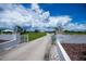 Grand gated entrance leading to a sprawling property with manicured lawns and lush greenery at 17400 White Water Ct, Punta Gorda, FL 33982