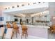 Open kitchen with center island, breakfast bar, white countertops, and unique decorative accents above cabinets at 17400 White Water Ct, Punta Gorda, FL 33982