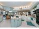 Well-lit kitchen featuring an island, light blue cabinets, stainless steel appliances, and an open layout at 17400 White Water Ct, Punta Gorda, FL 33982