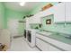 Laundry room with a washer and dryer, green countertops, and ample storage at 17400 White Water Ct, Punta Gorda, FL 33982