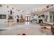 Spacious living room with tiered tile flooring, elevated display shelves, and double-door entry at 17400 White Water Ct, Punta Gorda, FL 33982