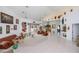 Bright living room with high ceilings, white tile flooring, and a view of the lanai at 17400 White Water Ct, Punta Gorda, FL 33982