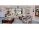 Bright living room features comfortable seating, natural light, and pool view at 17400 White Water Ct, Punta Gorda, FL 33982