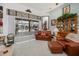 Comfortable living room featuring a leather sofa, plush rug, and sliding glass doors to the pool area at 17400 White Water Ct, Punta Gorda, FL 33982