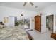 View of bright main bedroom with sliding glass doors leading to the outdoors and an ensuite bathroom at 17400 White Water Ct, Punta Gorda, FL 33982