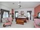 Comfortable main bedroom with sitting area, dresser, and windows at 17400 White Water Ct, Punta Gorda, FL 33982