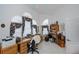 Bright room with arched windows with floral curtains, a ceiling fan, and a desk at 17400 White Water Ct, Punta Gorda, FL 33982