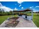 Fully equipped outdoor kitchen and dining area offers a perfect space for grilling and entertaining guests outdoors at 17400 White Water Ct, Punta Gorda, FL 33982