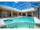 Lanai featuring pool with built-in bar, and spa, plus multiple seating areas and wet bar at 17400 White Water Ct, Punta Gorda, FL 33982