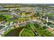 An aerial view of a community featuring a golf course, a pond, and well-maintained landscaping at 1812 Birmingham Blvd, Punta Gorda, FL 33980