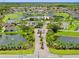An aerial view of a community featuring ponds, a golf course, and a community center at 1812 Birmingham Blvd, Punta Gorda, FL 33980