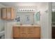 Bathroom featuring a double sink vanity with ample drawers, a large mirror, cabinet storage and walk-in shower at 1812 Birmingham Blvd, Punta Gorda, FL 33980