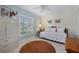 Cozy bedroom featuring a daybed, window with shutters, white walls, round rug and white chest of drawers at 1812 Birmingham Blvd, Punta Gorda, FL 33980