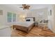 Bright bedroom with hardwood floors, neutral walls, a ceiling fan and plantation shutters for ample natural light at 1812 Birmingham Blvd, Punta Gorda, FL 33980