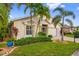 Well-maintained home with an attached two-car garage, mature palm trees, and lush landscaping at 1812 Birmingham Blvd, Punta Gorda, FL 33980