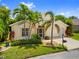 Charming single-story home with well-manicured lawn, mature palm trees, and a two-car garage at 1812 Birmingham Blvd, Punta Gorda, FL 33980