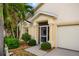 Charming home featuring a screened-in front porch, well-kept landscaping, and an attached two-car garage at 1812 Birmingham Blvd, Punta Gorda, FL 33980
