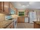 Bright kitchen featuring stainless steel appliances, granite countertops, and plenty of cabinet space for storage at 1812 Birmingham Blvd, Punta Gorda, FL 33980