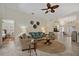 Comfortable living room with neutral tones, tile floors, ceiling fan, and views into adjacent rooms at 1812 Birmingham Blvd, Punta Gorda, FL 33980