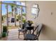 Inviting front patio seating area with tiled floor, decor mirror and beautiful views of the landscaped front yard at 1812 Birmingham Blvd, Punta Gorda, FL 33980