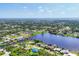 Beautiful aerial view of homes nestled along a scenic waterway with lush landscaping and open spaces at 18585 Klingler Cir, Port Charlotte, FL 33948