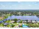 Scenic aerial view of a neighborhood, showcasing waterfront homes with boat docks along a river at 18585 Klingler Cir, Port Charlotte, FL 33948