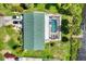 Top-down view of a home with a pool, well-maintained yard, and parked cars, capturing an overview of the property at 18585 Klingler Cir, Port Charlotte, FL 33948