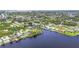 Scenic aerial shot of waterfront homes with private docks along a tranquil waterway surrounded by greenery at 18585 Klingler Cir, Port Charlotte, FL 33948