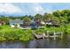 Aerial shot showcasing a waterfront property with dock, pool, and lush tropical landscaping at 18585 Klingler Cir, Port Charlotte, FL 33948