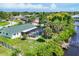 Overhead view of a home featuring a screened pool, dock, and spacious backyard with green lawn at 18585 Klingler Cir, Port Charlotte, FL 33948